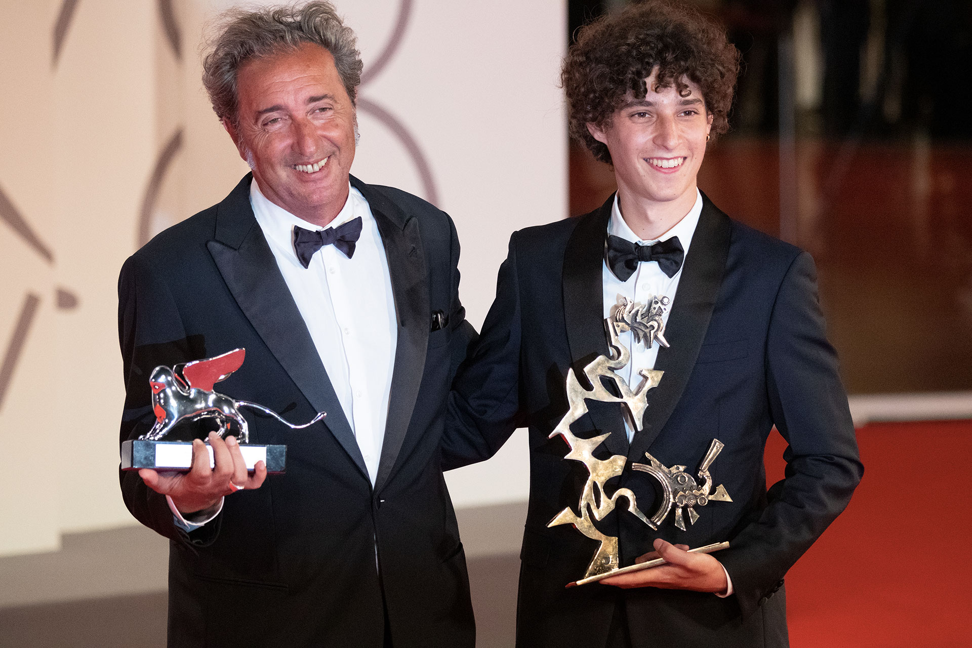 Director Paolo Sorrentino poses with the Silver Lion Grand Jury Prize for 